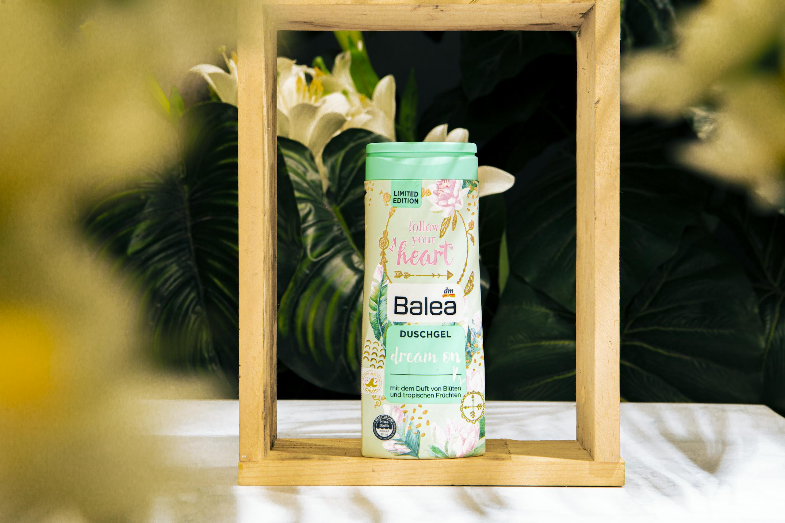 Limited edition tropical shower gel in artistic wooden frame with lush botanicals.